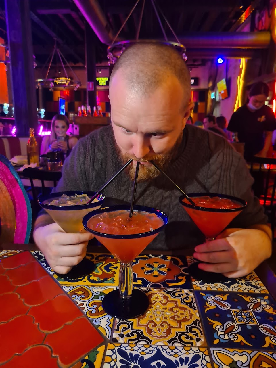 A guest holding frozen margaritas at El Camino Cantina The Rocks